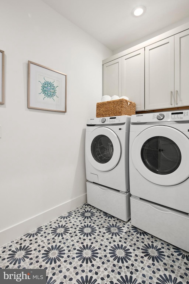 clothes washing area with recessed lighting, washing machine and dryer, cabinet space, and baseboards