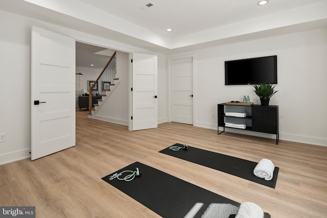 workout room with recessed lighting, visible vents, baseboards, and wood finished floors