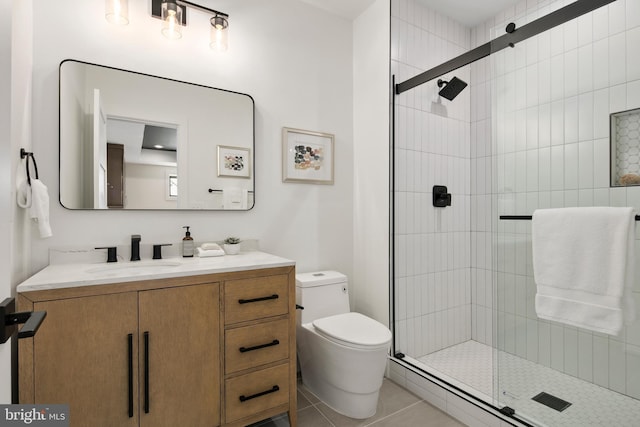 full bathroom featuring vanity, a shower stall, toilet, and tile patterned floors