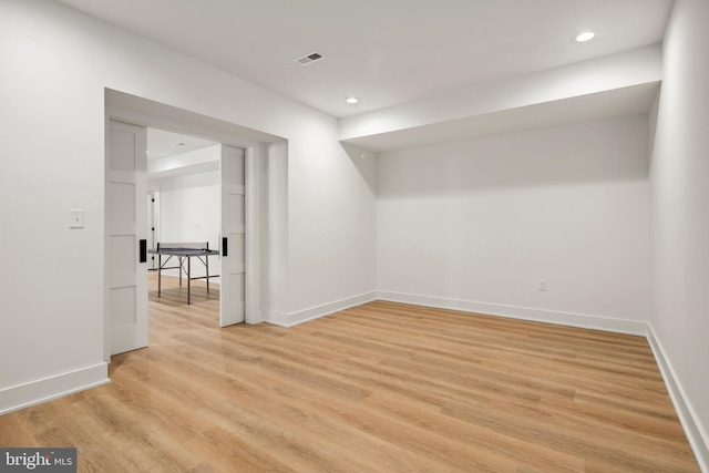 basement with recessed lighting, baseboards, visible vents, and light wood finished floors