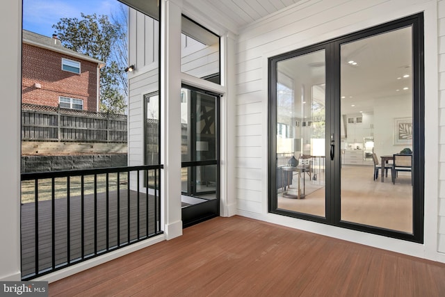 entryway featuring wooden walls and wood finished floors