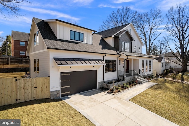 modern farmhouse featuring driveway, roof with shingles, fence, and a gate