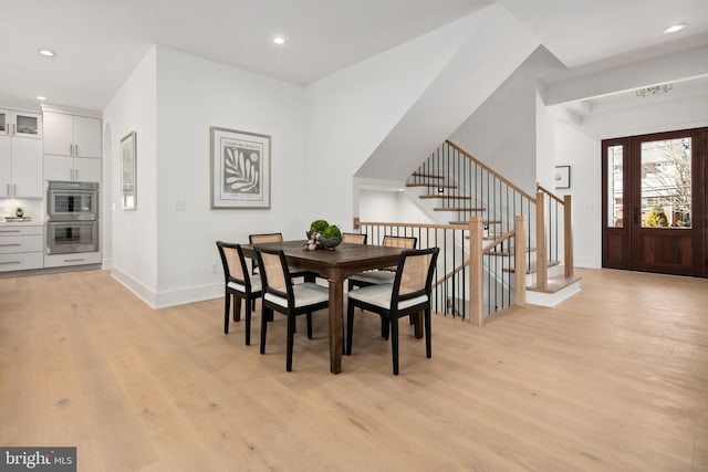 dining area with stairs, light wood-type flooring, baseboards, and recessed lighting