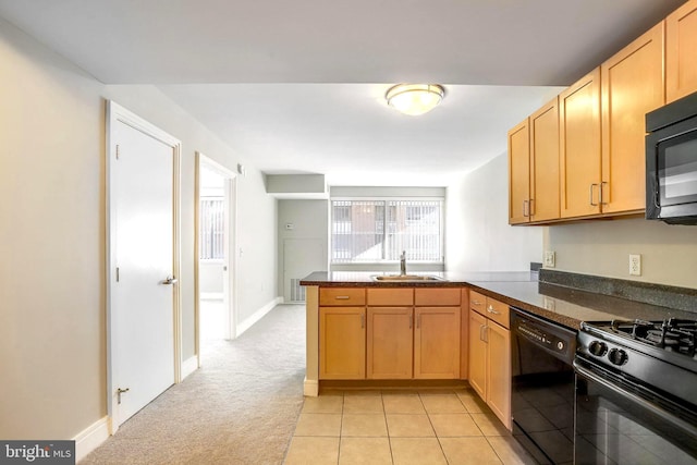 kitchen with light colored carpet, a peninsula, a sink, black appliances, and dark countertops