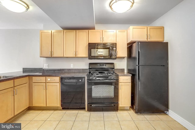 kitchen with light tile patterned flooring, baseboards, light brown cabinetry, black appliances, and dark countertops