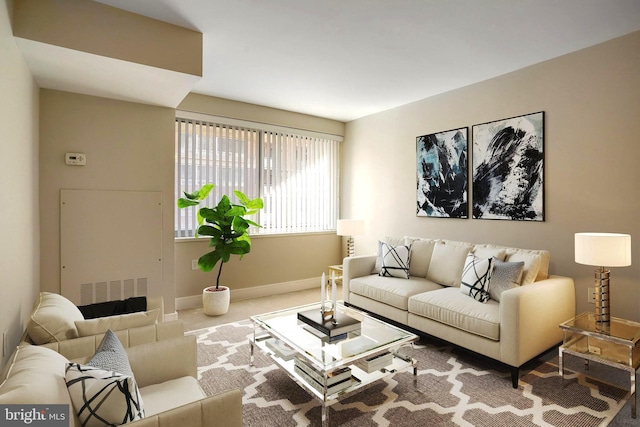 carpeted living area featuring visible vents and baseboards