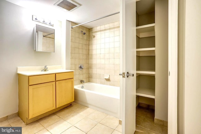 bathroom with visible vents, built in features,  shower combination, tile patterned flooring, and vanity