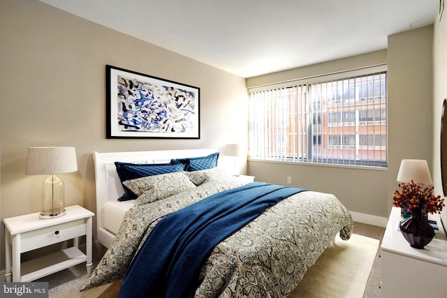 bedroom featuring carpet floors and baseboards