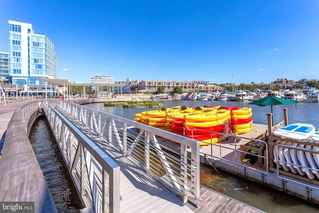 dock area featuring a water view and a city view