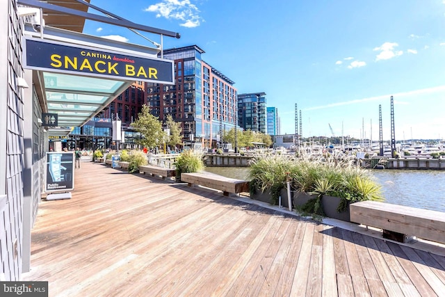 wooden terrace with a water view and a city view