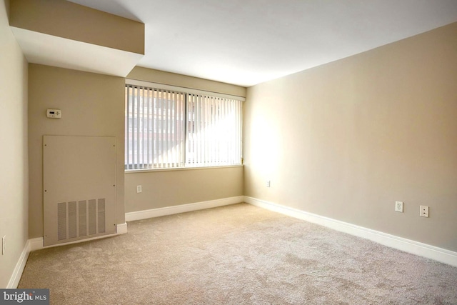 spare room with carpet floors and baseboards