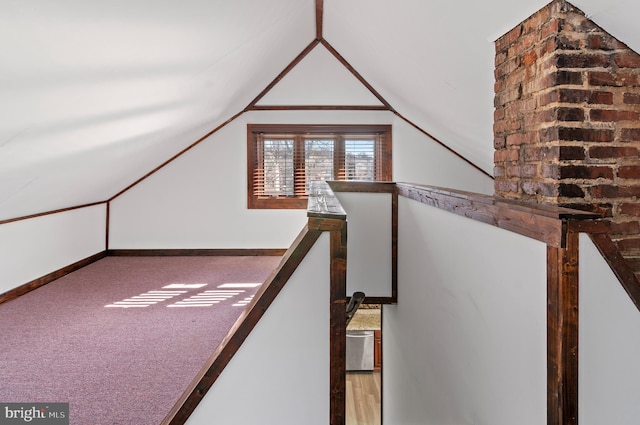 bonus room featuring baseboards, vaulted ceiling, and carpet flooring