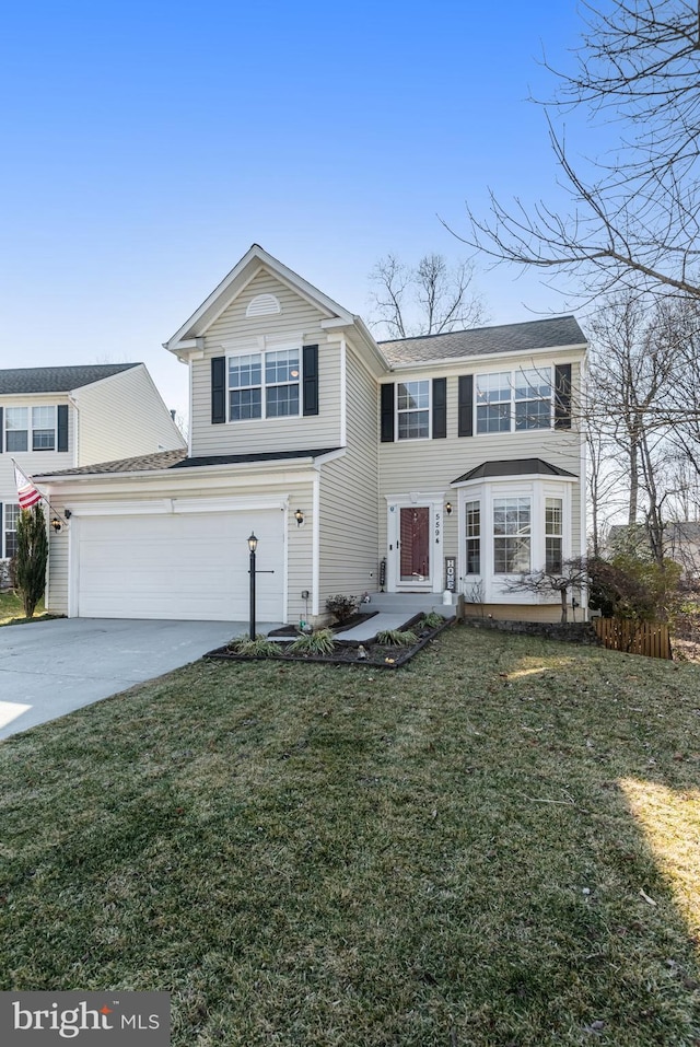 traditional-style home with a front yard, concrete driveway, and an attached garage