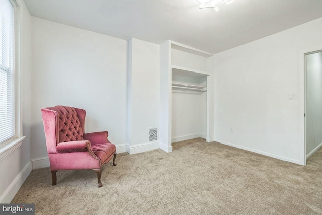 sitting room featuring carpet, visible vents, and baseboards