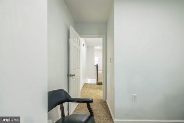 hall with carpet and baseboards