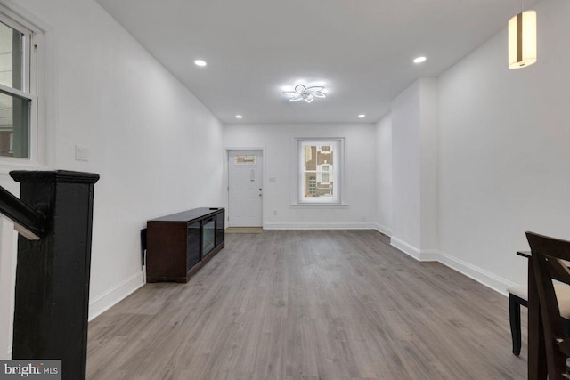 foyer featuring recessed lighting, wood finished floors, and baseboards