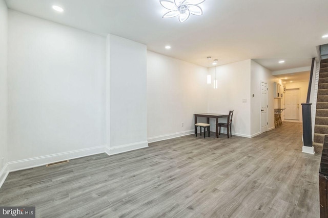 interior space with recessed lighting, wood finished floors, visible vents, baseboards, and stairs