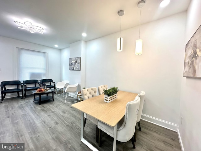 dining room with recessed lighting, wood finished floors, and baseboards