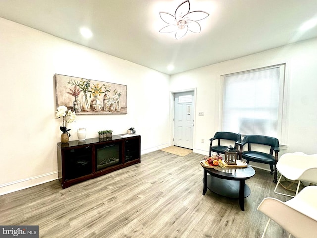 sitting room featuring baseboards and wood finished floors