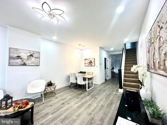 living room with stairs, baseboards, wood finished floors, and recessed lighting