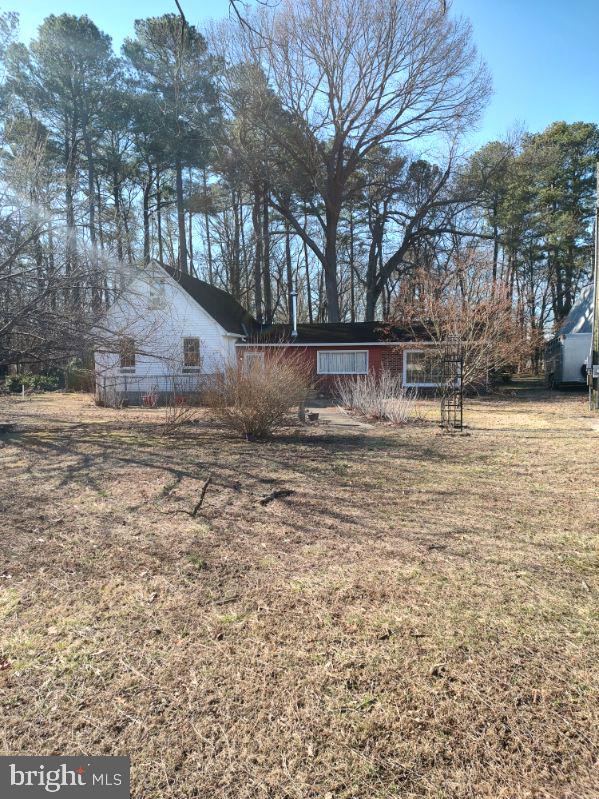 view of side of property with a lawn