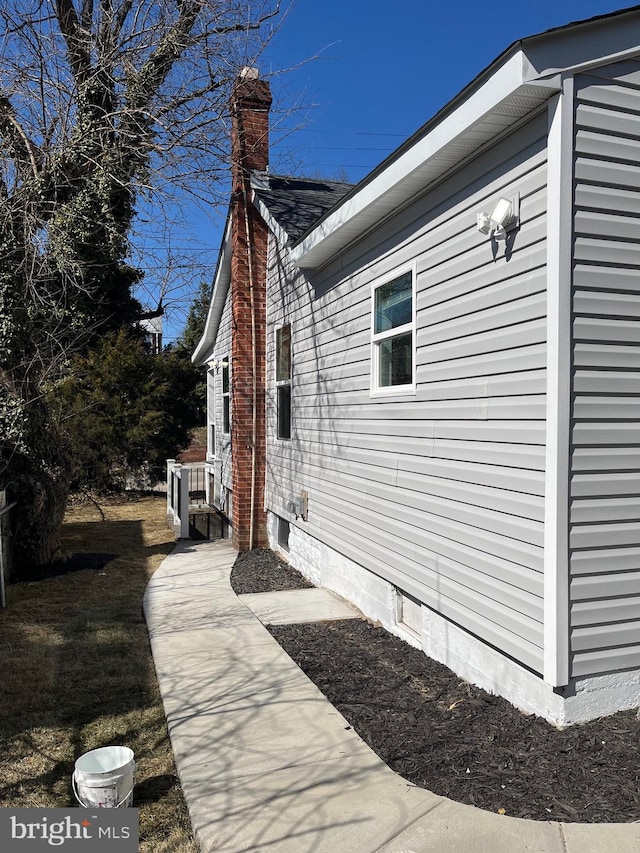 view of property exterior with a chimney