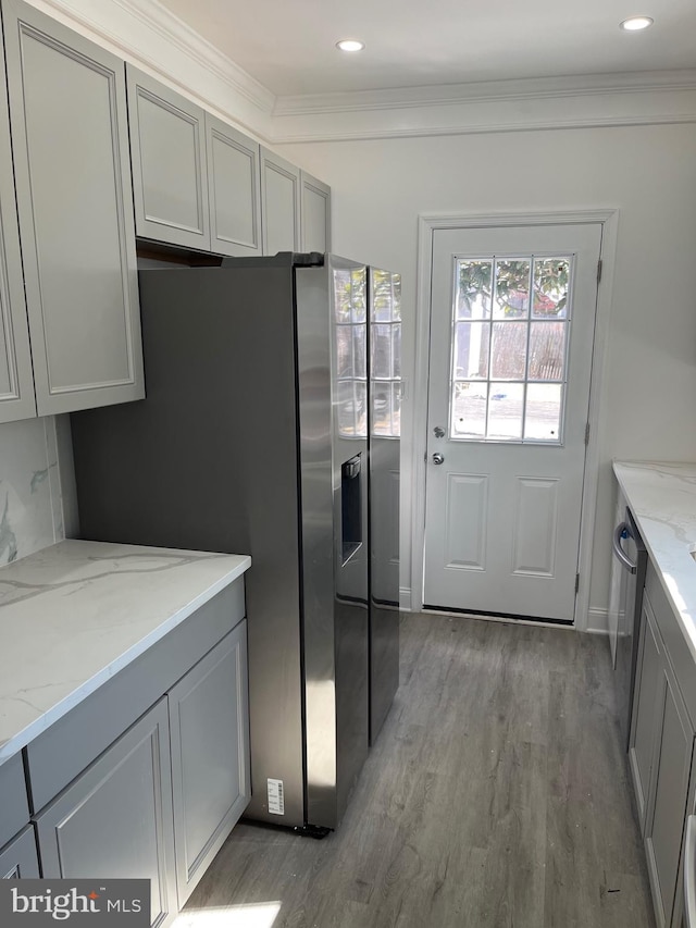 kitchen with ornamental molding, gray cabinets, and light wood finished floors