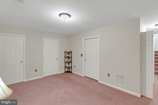 interior space with stairway, carpet flooring, visible vents, and baseboards