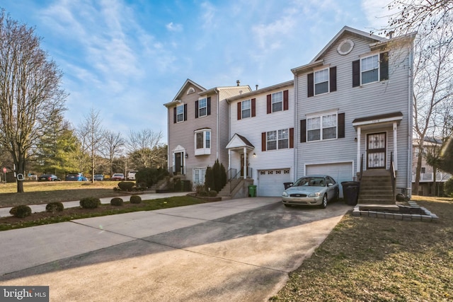 view of front facade featuring concrete driveway and an attached garage