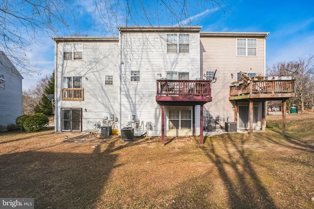 back of house featuring a deck, central AC unit, and a lawn