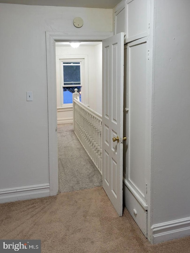 hallway with light carpet