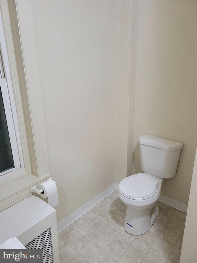 bathroom featuring toilet and baseboards