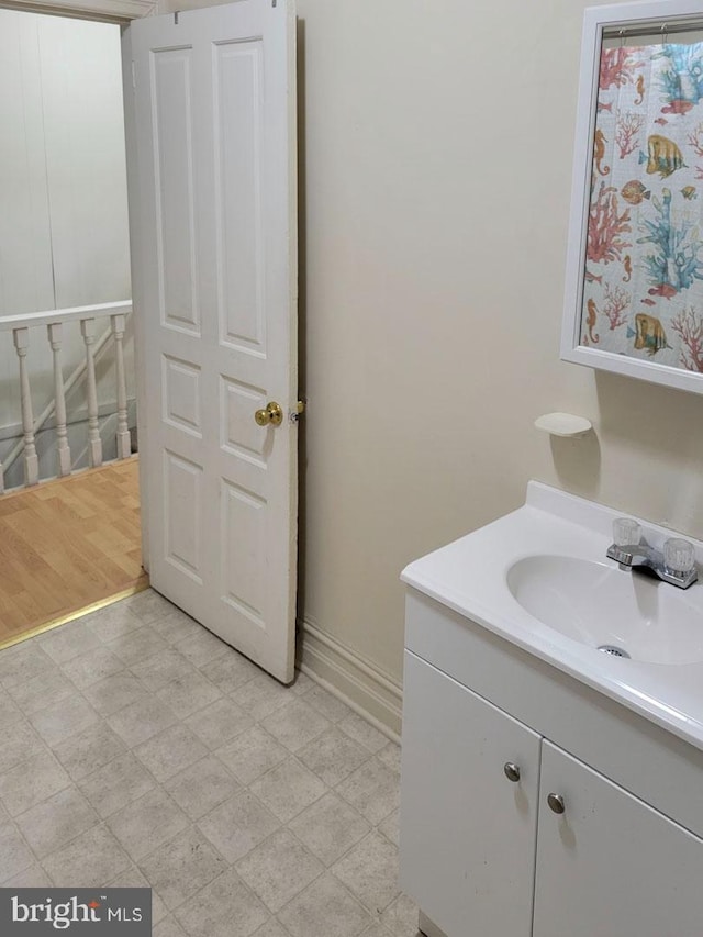 bathroom featuring baseboards, vanity, and tile patterned floors