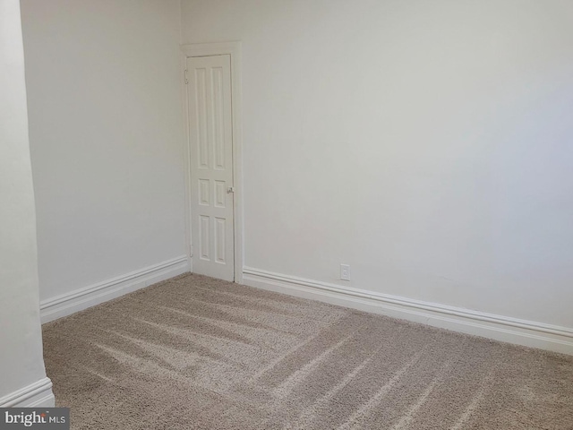 empty room with carpet floors and baseboards