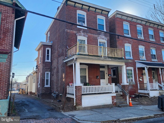 multi unit property with covered porch and brick siding