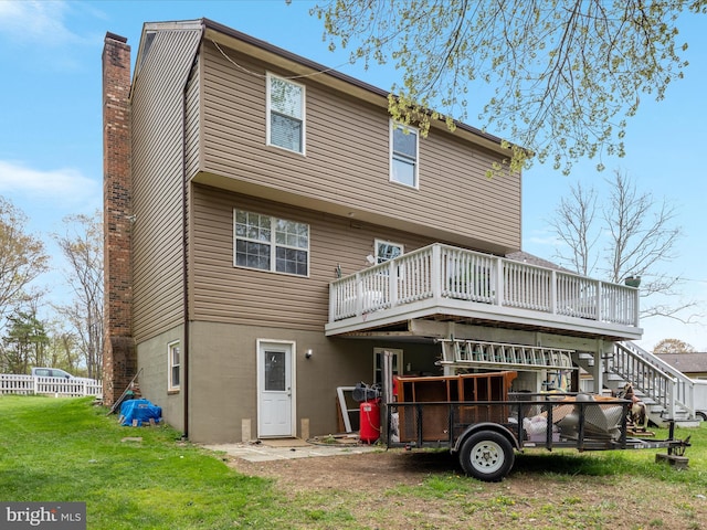 244 Raintree Blvd, Stafford, VA 22556 - rear view of house with a lawn, a chimney, stairway, fence, and a wooden deck
