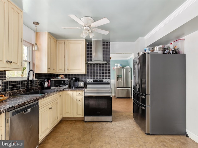 244 Raintree Blvd, Stafford, VA 22556 - kitchen with wall chimney range hood, cream cabinets, dark countertops, appliances with stainless steel finishes, and a sink
