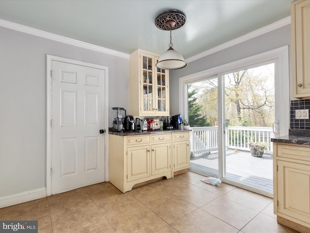 244 Raintree Blvd, Stafford, VA 22556 - kitchen featuring crown molding, cream cabinetry, tasteful backsplash, and glass insert cabinets