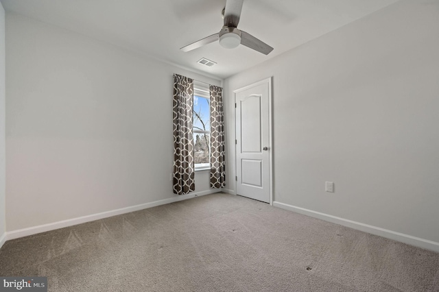 spare room with visible vents, baseboards, ceiling fan, and carpet flooring