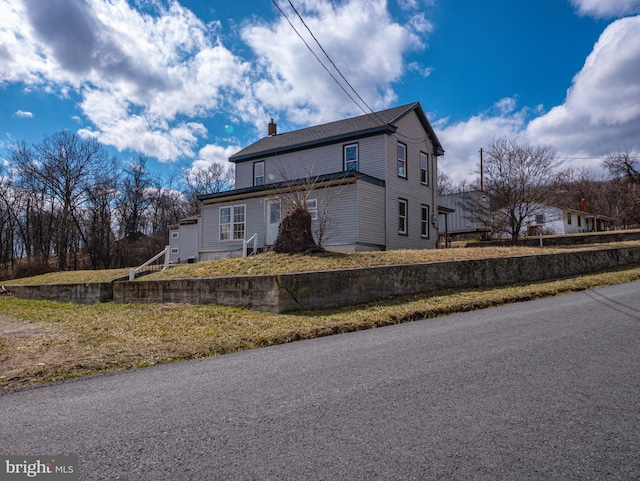 view of side of property featuring a chimney