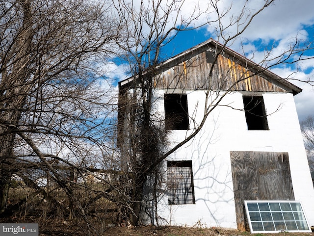 view of property exterior with an outdoor structure and a barn