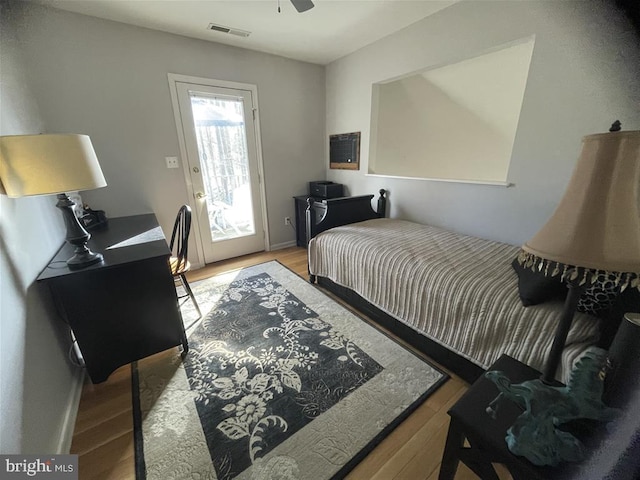 bedroom with light wood-style flooring and visible vents