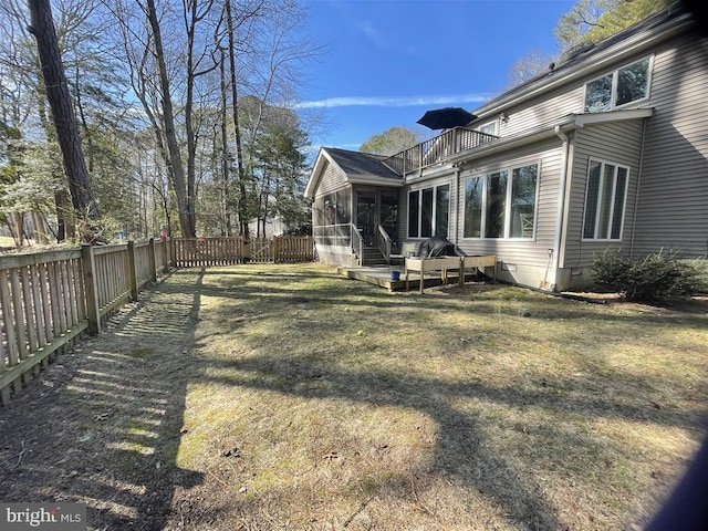 view of yard with fence and a sunroom