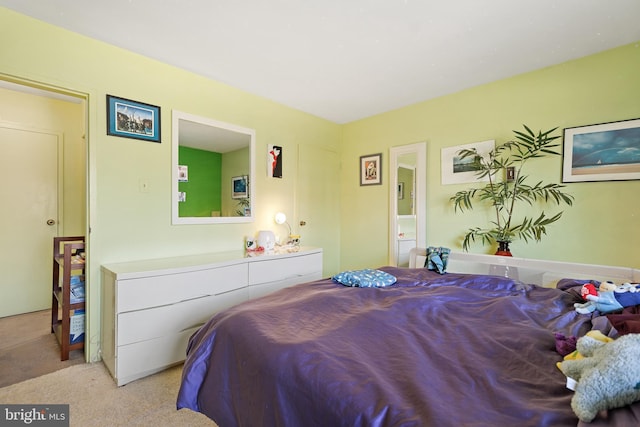 bedroom featuring light colored carpet