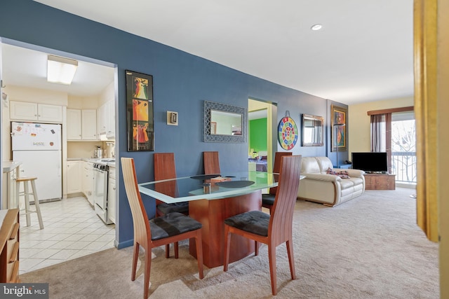 dining area featuring recessed lighting, light carpet, and light tile patterned floors