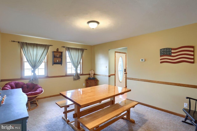 dining space with carpet and baseboards