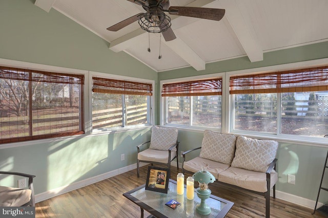 sunroom featuring a ceiling fan and lofted ceiling with beams