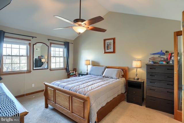 bedroom featuring light carpet, vaulted ceiling, baseboards, and ceiling fan