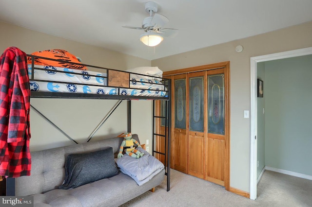 bedroom with baseboards and light colored carpet