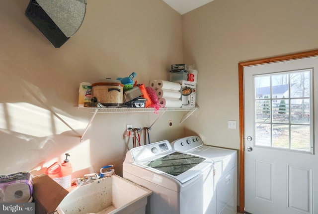 clothes washing area with plenty of natural light, laundry area, independent washer and dryer, and a sink